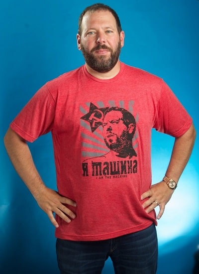 A picture of Bert Kreischer wearing his t-shirt merch.